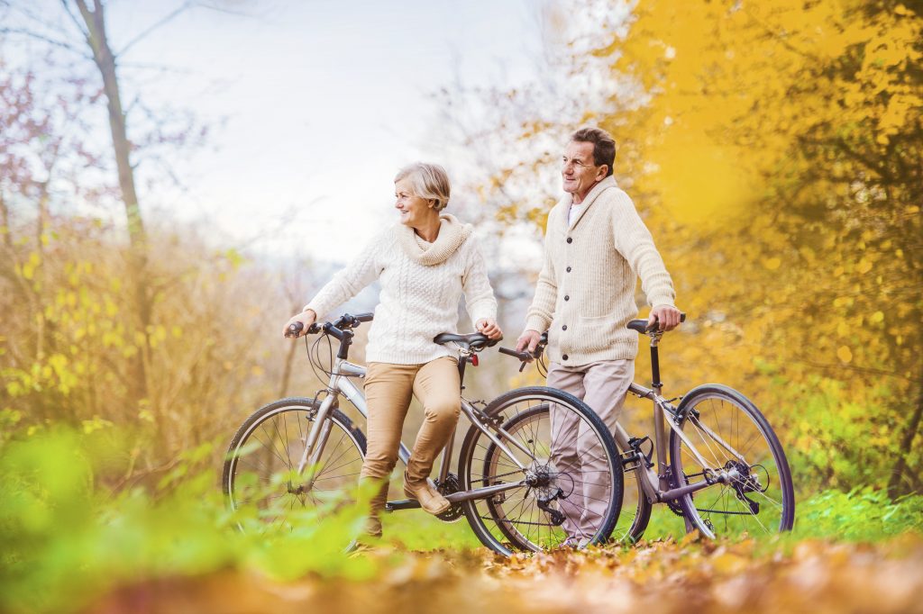 graphicstock active seniors riding bikes in autumn nature they having romantic time outdoor SRl2jzVp W