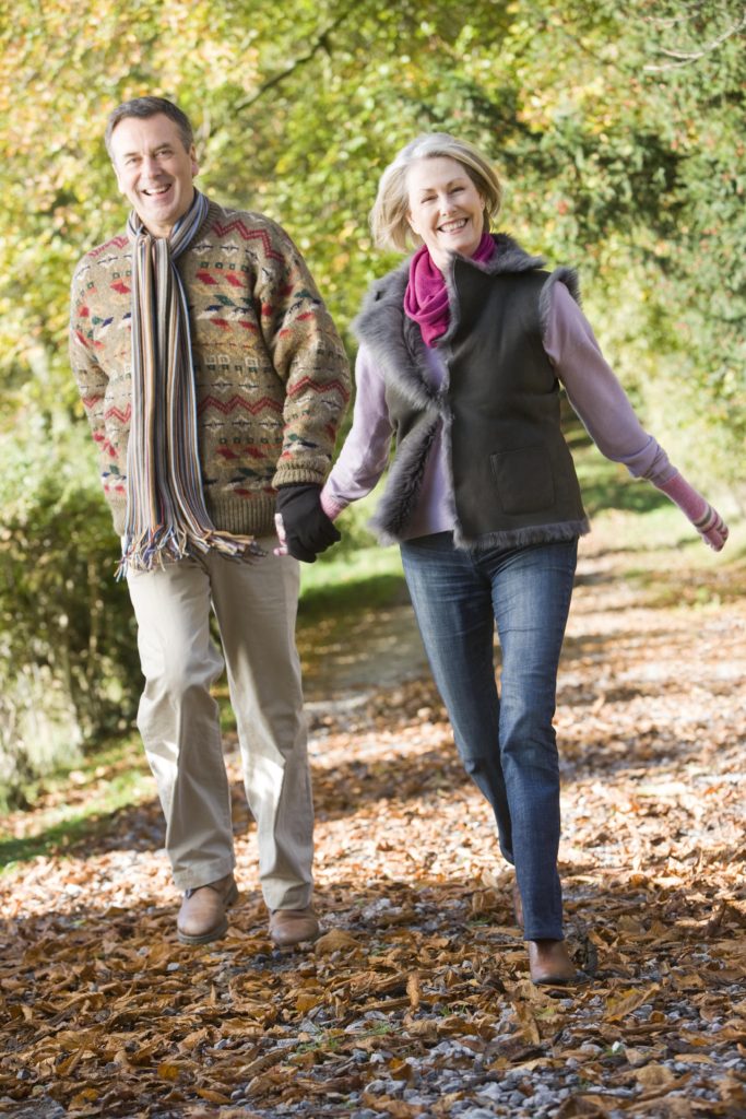 senior couple walking along path in autumn woods HYPYeRrs SBI x